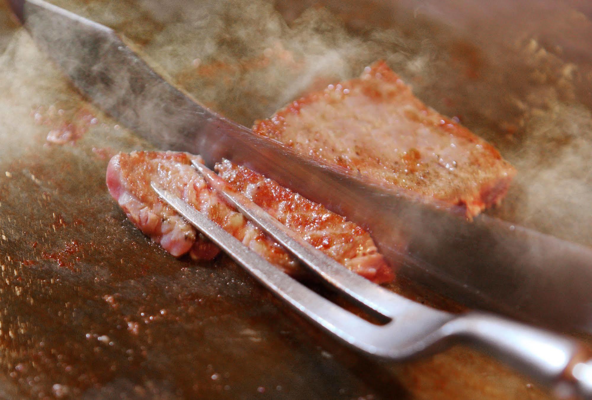 Asaya Hotel Нико Екстериор снимка A meat fork being used to serve meat